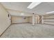 Finished basement area featuring neutral carpet, access to upper floors, and storage at 17390 E Greenwood Cir, Aurora, CO 80013