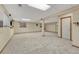 Large finished basement with neutral carpet, recessed lighting, and access to storage at 17390 E Greenwood Cir, Aurora, CO 80013