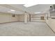 Spacious finished basement with neutral carpet and exposed ceiling at 17390 E Greenwood Cir, Aurora, CO 80013