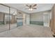 Bedroom featuring plush carpet, a mirror closet, and an ensuite bathroom at 17390 E Greenwood Cir, Aurora, CO 80013