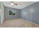 Bedroom with carpet, blue walls, and a window overlooking the backyard at 17390 E Greenwood Cir, Aurora, CO 80013