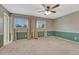 Spacious bedroom with neutral carpet, two-tone walls, and a ceiling fan at 17390 E Greenwood Cir, Aurora, CO 80013