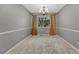 Cozy dining room with neutral carpet, chandelier, and a large window at 17390 E Greenwood Cir, Aurora, CO 80013