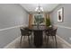 Bright dining room featuring seating for six, neutral walls, carpet, and a modern light fixture at 17390 E Greenwood Cir, Aurora, CO 80013