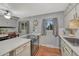 Cozy kitchen offers modern appliances, light countertops, a ceiling fan and hardwood floors at 17390 E Greenwood Cir, Aurora, CO 80013