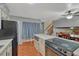 Kitchen featuring modern appliances, tile floors, and an open view into the dining area at 17390 E Greenwood Cir, Aurora, CO 80013