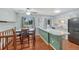 Eat-in kitchen featuring a breakfast bar and wood floors, providing a cozy and functional space at 17390 E Greenwood Cir, Aurora, CO 80013