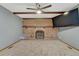 Comfortable living room with a brick fireplace, carpeted floors, and a ceiling fan for added comfort at 17390 E Greenwood Cir, Aurora, CO 80013