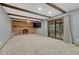 Spacious carpeted living room featuring a beautiful brick fireplace, exposed beams and lots of light at 17390 E Greenwood Cir, Aurora, CO 80013
