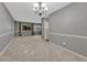 Open-concept living area with neutral carpet and an adjacent dining area, great for gatherings at 17390 E Greenwood Cir, Aurora, CO 80013