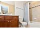 Bathroom featuring a vanity, toilet, and tiled shower-tub combo with a shower curtain at 3401 N Xenia St, Denver, CO 80238
