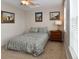 Cozy bedroom featuring a patterned queen bed, neutral walls, and two windows at 3401 N Xenia St, Denver, CO 80238
