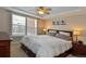 Serene bedroom features a tray ceiling, plush carpeting, and natural light from a window overlooking the neighborhood at 3401 N Xenia St, Denver, CO 80238