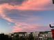 Sunset over city rooftops with vivid pink and purple clouds at 3401 N Xenia St, Denver, CO 80238