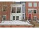 Charming townhome featuring brick and siding exterior, front porch, and well-maintained landscaping during winter season at 3401 N Xenia St, Denver, CO 80238