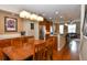 Open-concept kitchen features wooden cabinets, stainless steel appliances, and adjacent dining area at 3401 N Xenia St, Denver, CO 80238