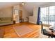 Open living space featuring hardwood floors, a comfortable sofa, and access to the outside at 3401 N Xenia St, Denver, CO 80238