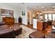 Cozy living room featuring wood floors, a comfortable seating area, and an open layout leading to the kitchen at 3401 N Xenia St, Denver, CO 80238