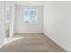 Well-lit bedroom featuring neutral carpet, white walls, and a window for natural light at 17969 Dandy Brush Ln, Parker, CO 80134