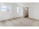 Bright bedroom with neutral carpet, large windows, and an ensuite bathroom at 17969 Dandy Brush Ln, Parker, CO 80134