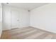 An empty bedroom featuring neutral carpet, white walls, a window, and a closet door at 17969 Dandy Brush Ln, Parker, CO 80134
