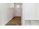 Inviting entryway with hardwood floors, a storage bench, and a white front door at 17969 Dandy Brush Ln, Parker, CO 80134