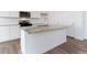 Close-up of the kitchen island featuring granite countertops and stainless steel faucet at 17969 Dandy Brush Ln, Parker, CO 80134