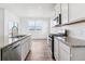 Modern kitchen featuring stainless steel appliances, granite counters, and white cabinets at 17969 Dandy Brush Ln, Parker, CO 80134