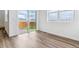 Bright living space with large windows, modern flooring, and sliding door access to yard at 17969 Dandy Brush Ln, Parker, CO 80134