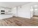 Bright open-concept living space with modern flooring and seamlessly connected to the kitchen at 17969 Dandy Brush Ln, Parker, CO 80134