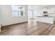 Bright living space with large windows, modern flooring, and seamlessly connected kitchen at 17969 Dandy Brush Ln, Parker, CO 80134