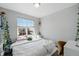 Bright bedroom featuring a large window and plush bedding at 27857 E 8Th Ave, Aurora, CO 80018
