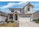 Charming two-story home with a covered porch and a two-car garage, and a well-maintained lawn at 27857 E 8Th Ave, Aurora, CO 80018