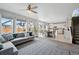 Open-concept living area with large windows, connecting to dining and modern kitchen at 27857 E 8Th Ave, Aurora, CO 80018