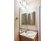 Bathroom with modern lighting fixture, vanity and mirror at 18189 E Saskatoon Pl, Parker, CO 80134