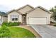 Charming single-story home with manicured lawn, covered entry, and attached two-car garage at 22026 Hill Gail Way, Parker, CO 80138