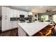 Modern kitchen with white cabinetry, stainless steel appliances, and a large center island at 22026 Hill Gail Way, Parker, CO 80138