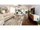 Spacious open-concept living room showcasing hardwood floors and seamless flow to the kitchen at 22026 Hill Gail Way, Parker, CO 80138