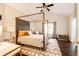 Cozy bedroom with a four-post bed, stylish decor, and an ensuite bathroom at 22026 Hill Gail Way, Parker, CO 80138