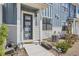 Inviting front entrance with a modern door, a seating area and a well maintained landscape at 7885 Yampa River Ave, Littleton, CO 80125