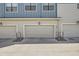 A row of garages with neutral doors, marked with unit numbers, providing ample parking for residents at 7885 Yampa River Ave, Littleton, CO 80125