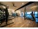 Well-equipped gym with modern exercise machines, weights, and hardwood floors, promoting a healthy lifestyle at 7885 Yampa River Ave, Littleton, CO 80125