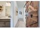 Hallway featuring a sliding barn door and full bathroom view at 7885 Yampa River Ave, Littleton, CO 80125