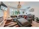 Bright living room featuring a comfortable sofa, stylish decor, and a large window at 7885 Yampa River Ave, Littleton, CO 80125