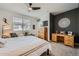 Bright main bedroom with a ceiling fan, closet and decorative wall art at 7885 Yampa River Ave, Littleton, CO 80125