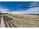 Expansive field with power lines overhead, showcasing the natural surroundings of the neighborhood at 7885 Yampa River Ave, Littleton, CO 80125