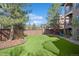 Spacious backyard with artificial turf, a playground, and a wooden fence for privacy at 9617 Silent Hills Ln, Lone Tree, CO 80124