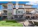 A backyard reveals a trampoline, patio furniture, and stone detailing on the house's exterior at 9617 Silent Hills Ln, Lone Tree, CO 80124