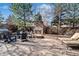 Outdoor patio featuring a stone fireplace, comfortable seating, and a built-in BBQ area at 9617 Silent Hills Ln, Lone Tree, CO 80124