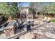 Outdoor patio with a stone fireplace, seating area, and built-in grill for entertaining at 9617 Silent Hills Ln, Lone Tree, CO 80124